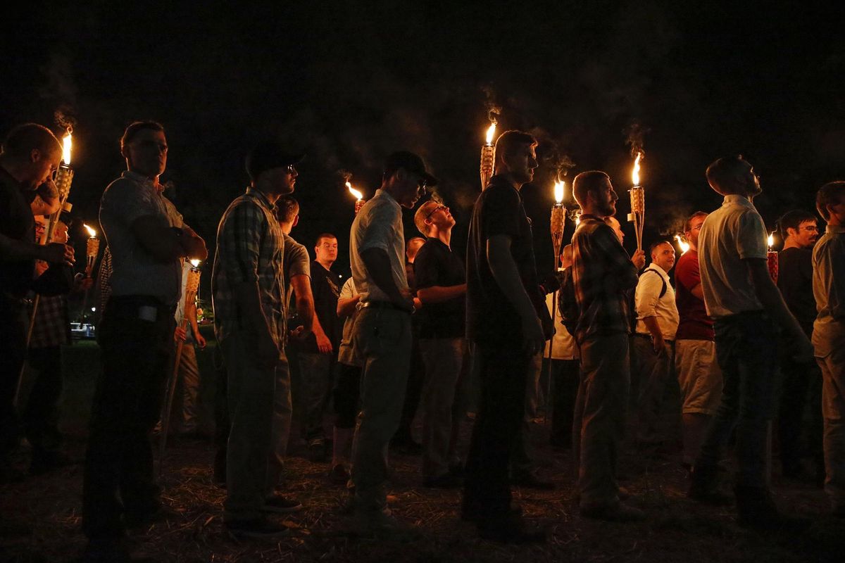 Multiple white nationalist groups march with torches Friday, Aug. 11, 2017, through the UVA campus in Charlottesville, Va. (Mykal McEldowney / AP)