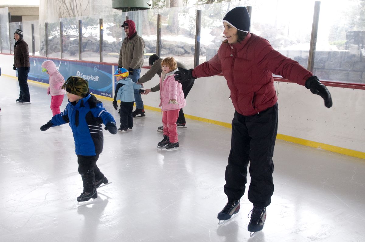Using a game of red light, green light, parents and children practice starting and stopping their ice skates  during a recent class at the Riverfront Park Ice Palace.  (Colin Mulvany / The Spokesman-Review)