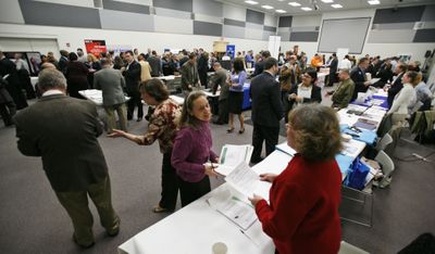 Former Circuit City paralegal Betsy Wade, center, hands her resume to recruiter Linda George  during a job fair at the headquarters of Circuit City in Richmond, Va. (Associated Press / The Spokesman-Review)