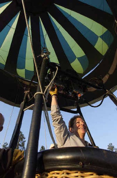 
Balloon pilot Val Faviccio keeps her hand on the gas burner as her crew steadies the gondola while a giant balloon stands up recently at North Idaho College. It was too windy to fly, so they laid it back down and put it away.Balloon pilot Val Faviccio keeps her hand on the gas burner as her crew steadies the gondola while a giant balloon stands up recently at North Idaho College. It was too windy to fly, so they laid it back down and put it away.
 (Jesse Tinsley/Jesse Tinsley/ / The Spokesman-Review)