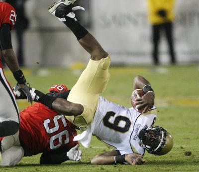 Georgia Tech quarterback Josh Nesbitt (9) is upended by Geno Atkins in the third quarter of the Bulldogs’ win.  (Associated Press)