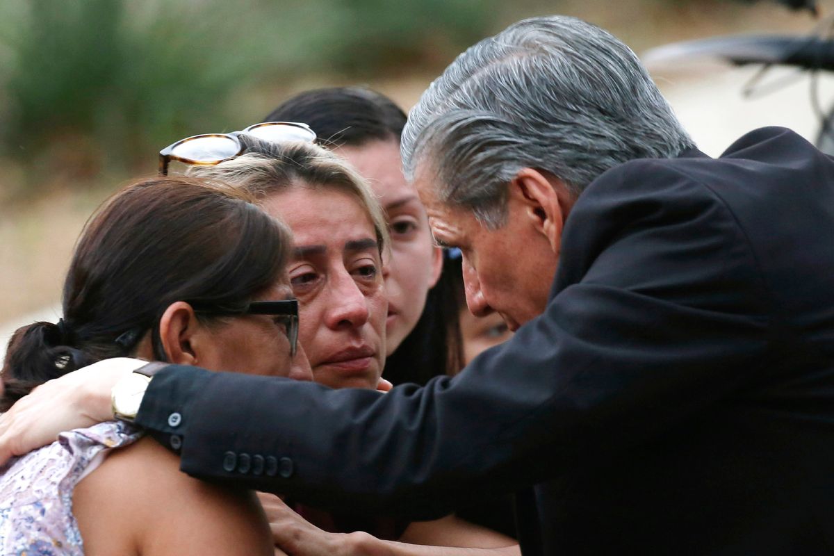 The archbishop of San Antonio, Gustavo Garcia-Siller, comforts families outside the Civic Center following a deadly school shooting at Robb Elementary School in Uvalde, Texas, Tuesday, May 24, 2022.  (Dario Lopez-Mills)
