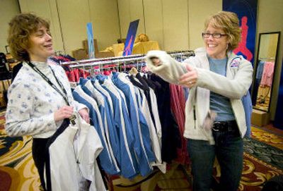 
Skating fans Joanne Spitler, left, and Jennifer Wenzke, both of Toledo, Ohio, shop for souvenirs from the 2006 U.S. Figure Skating Championships in St. Louis. 
 (Colin Mulvany / The Spokesman-Review)