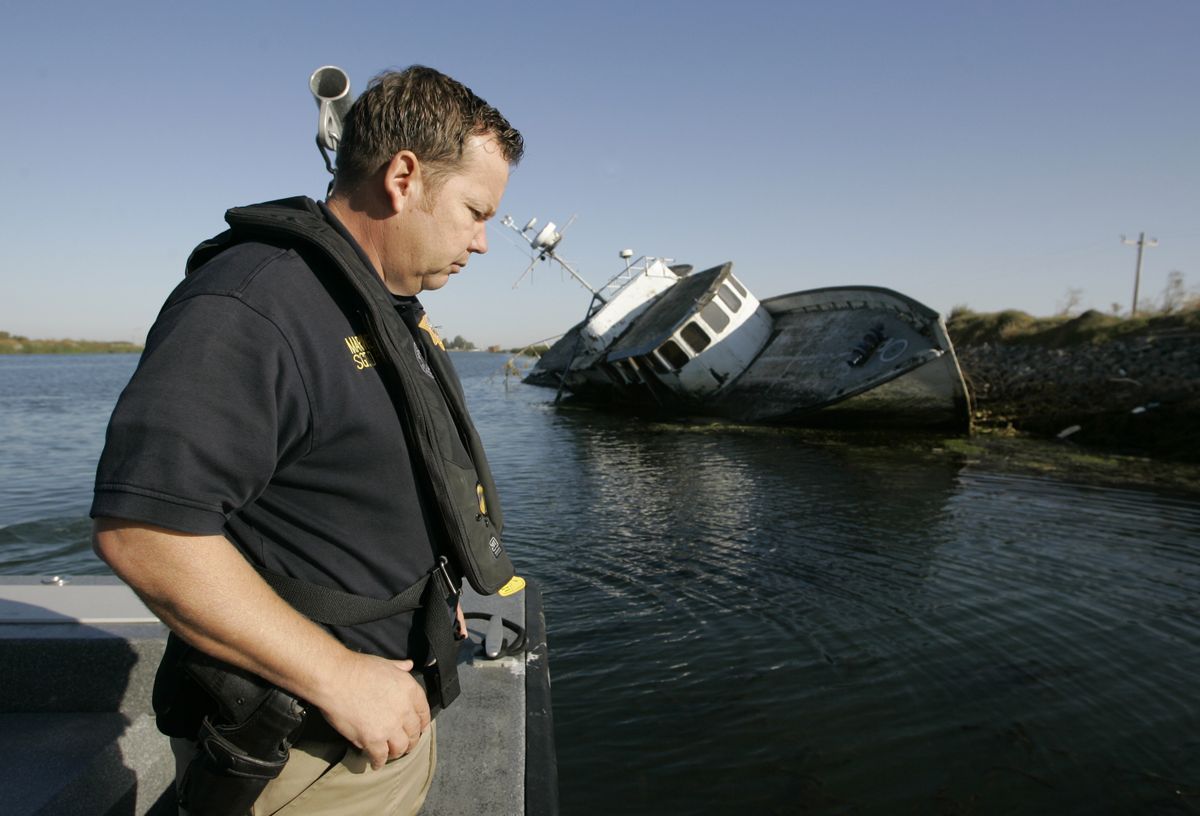 Sgt. Doug Powell, with the Contra Costa County sheriff’s marine services unit, looks over the water by an abandoned commercial vessel in Fisherman’s Cut near Bethel Island, Calif.Associated Press photos (Associated Press photos / The Spokesman-Review)