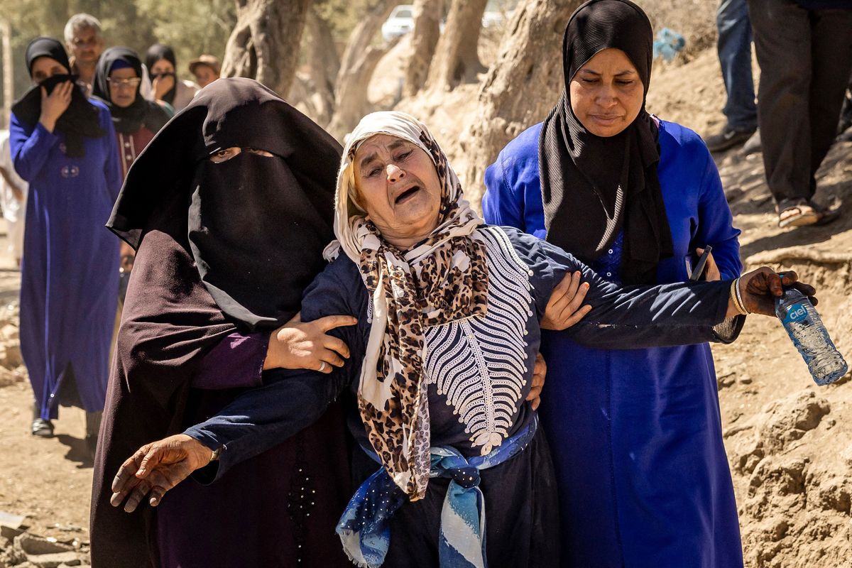 A woman is helped as she reacts to the death of relatives in an earthquake in the mountain village of Tafeghaghte, southwest of Marrakesh, Morocco, on Sunday.  (FADEL SENNA/AFP/Getty Images North America/TNS)