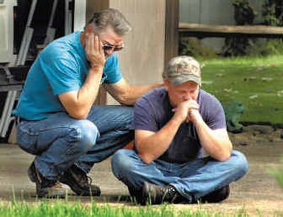 
David Kimball, left, comforts his son-in-law Darren Combee, Wednesday after their wives were found dead in an apparent murder-suicide that police believe the two had planned together inside Kimball's home in Eagle Point, Ore. 
 (Associated Press / The Spokesman-Review)