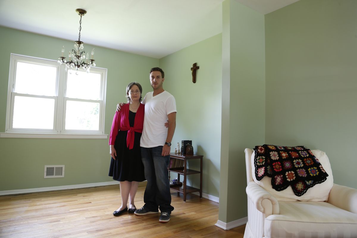In this portrait taken Wednesday, Aug. 22, 2012, Germaine Maurer, left, and her son Jared Maurer, 28, pose for the Associated Press in their home in Piscataway, N.J. Germaine Maurer's other son, Ben Maurer, went missing when he was 17 in 2002. He was identified through advanced DNA technology and new federal funding through a program aimed at identifying bodies at New York's Hart Island, better known as potter's field. Already the project has identified about 50 of the 54 bodies that have been disinterred. (Julio Cortez / Associated Press)