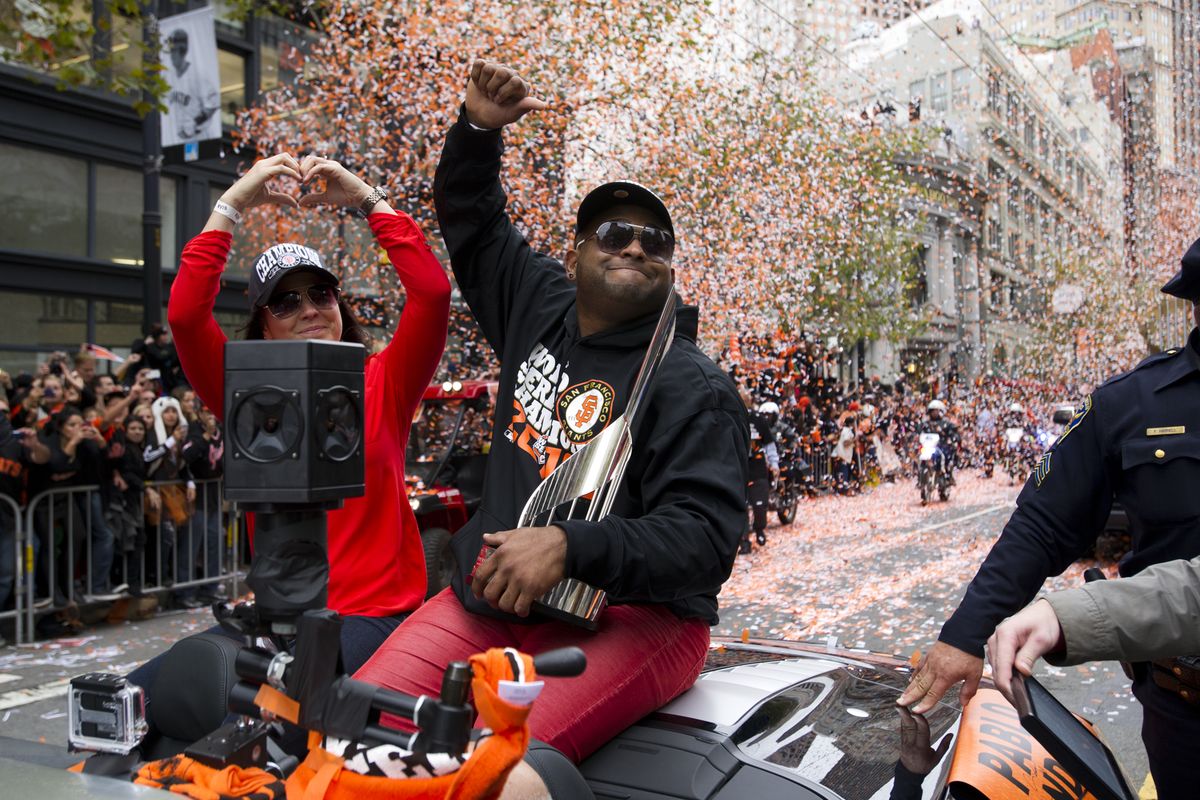 San Francisco Giants third baseman Pablo Sandoval waves to fans on Market Street during the parade in celebration of the baseball team