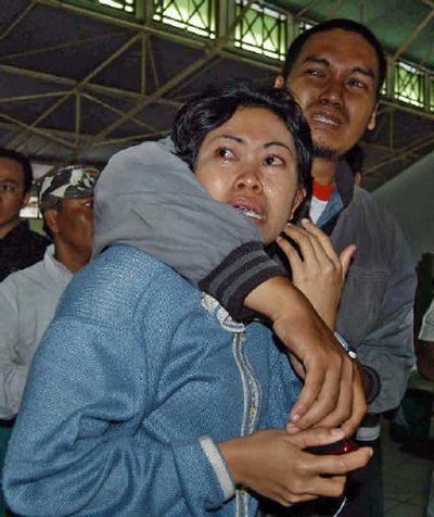 
Unidentified relatives of victims of a sunken ferry weep as they wait for news of the vessel at Tanjung Mas port in Semarang, Central Java, Indonesia, on Saturday. 
 (Associated Press / The Spokesman-Review)