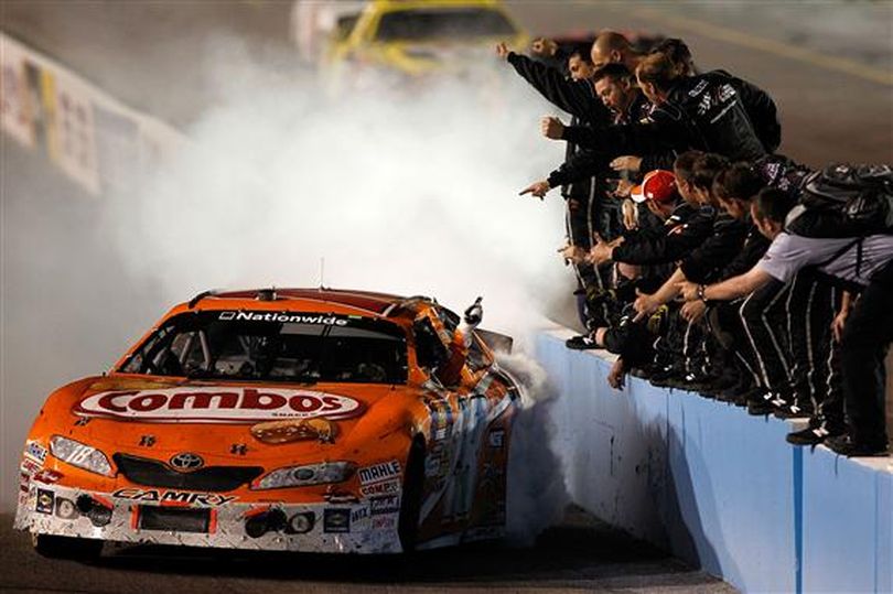 Kyle Busch celebrates his Bashas' Supermarkets 200 victory with a burnout for his Joe Gibbs Racing team. (Photo courtesy of Todd Warshaw/Getty Images for NASCAR)