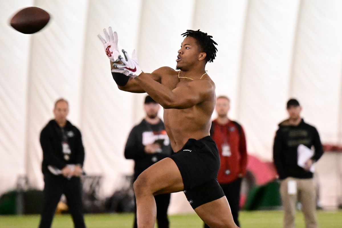 Washington State linebacker Daiyan Henley catches a pass as NFL scouts watch during pro day on Tuesday at the Cougars’ indoor practice field in Pullman.  (Tyler Tjomsland/The Spokesman-Review)