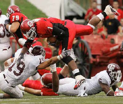
Utah running back Marty Johnson (1) gains seven yards before being tripped up by Texas A&M. 
 (Associated Press / The Spokesman-Review)