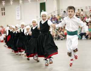 In this Saturday July 31, 2010 photo, John Lejardi, 6, right, and Tea Uranga, lead fellow dancers from the Basque dance group Herribatza Danzariak in Boise. One of the largest Basque communities in the United States will spend the next five days celebrating the traditional Jaialdi festival in southwestern Idaho. An estimated 35,000 to 50,000 people are expected to attend the event. (Darin Oswald / Idaho Statesman file photo)