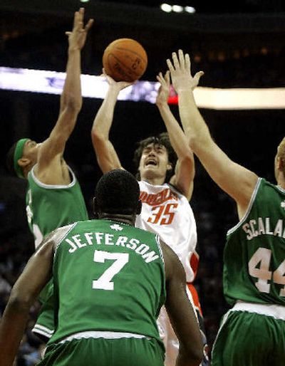 Adam Morrison shoots over Boston's Gerald Green, left, Al Jefferson and Brian Scalabrine.
 (Associated Press / The Spokesman-Review)