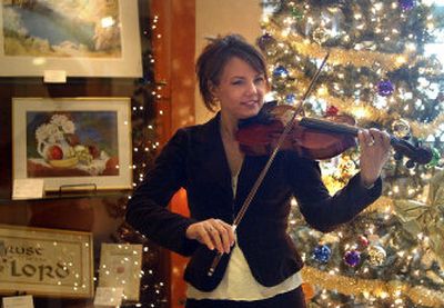 Artist Erin Griffin also plays the violin. Her paintings are on display at CenterPlace. Below, Griffin's painting