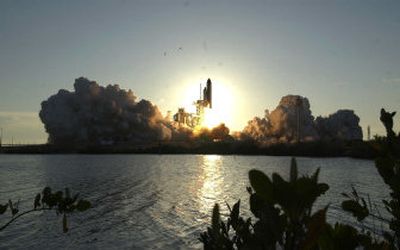 
Space shuttle Atlantis lifts off from the pad at Kennedy Space Center, Fla., on Friday evening. Atlantis is on an 11-day mission to the International Space Station. 
 (Associated Press / The Spokesman-Review)