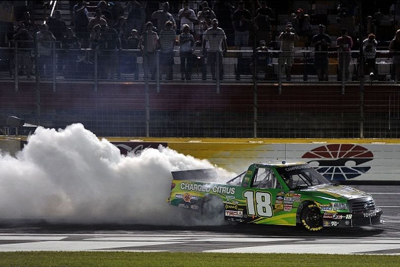 Kyle Busch celebrates winning the North Carolina Education Lottery 200 at Charlotte Motor Speedway with a burnout on the front stretch. (Photo Credit: Drew Hallowell/Getty Images for NASCAR) (Drew Hallowell / Getty Images North America)