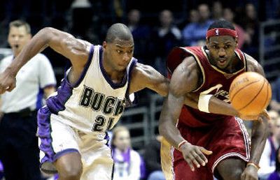 
Milwaukee's Bobby Simmons, left, attempts to beat Cleveland's LeBron James to a loose ball during the fourth quarter. 
 (Associated Press / The Spokesman-Review)