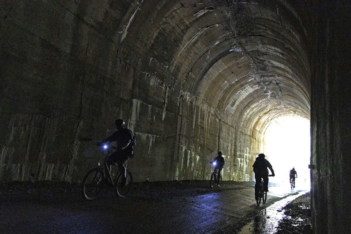 Bikers pass through one of the 10 tunnels (nine of which you can bike through) on the Route of the Hiawatha in North Idaho in June. (Justin Franz/For The Washington Post)