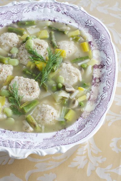 Spring vegetable soup with low-fat, high-flavor matzo balls can be served as the main course, or thinned and served for the first course of a Seder. (Associated Press)