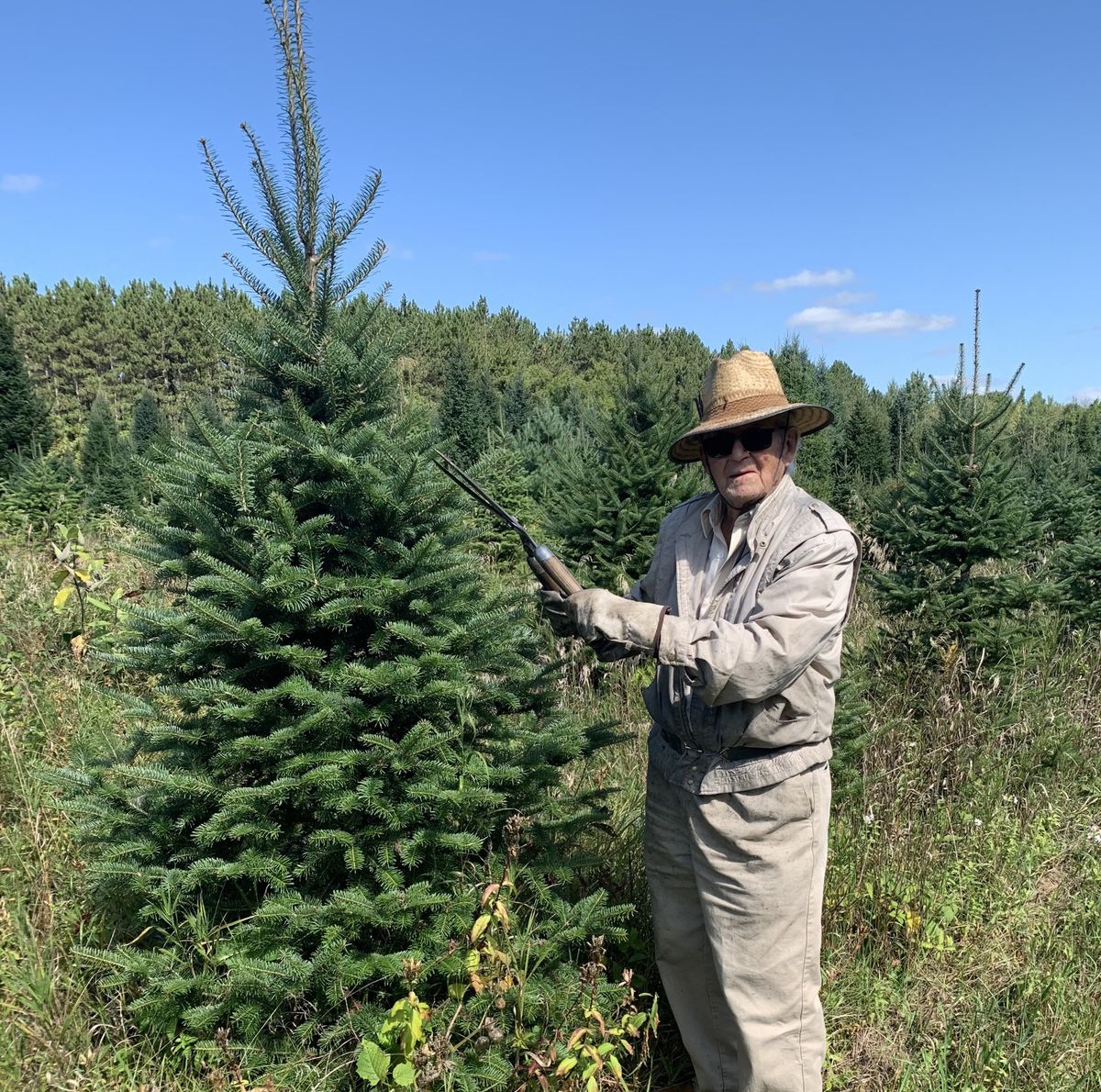 Pud Johnston pruning a Christmas tree on his farm in eastern Ontario. He opened the farm with his brother in 1952.  (Washington Post)