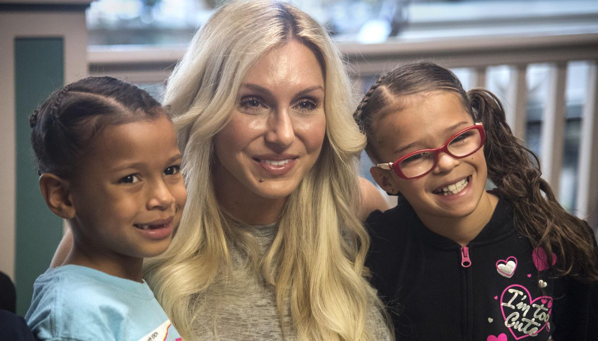 Janayah Santos, 7, left, and Jersey Ramey, 9, gather around WWE Smackdown Superstar Charlotte Flair for a snapshot, Sunday, Oct. 1, 2017, at Auntie’s Bookstore. (Dan Pelle / The Spokesman-Review)