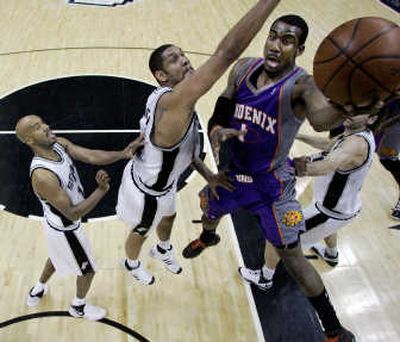 
The Suns' Amare Stoudemire, right, and Spurs' Tim Duncan, center, will meet again when their series opens today. Associated Press
 (Associated Press / The Spokesman-Review)