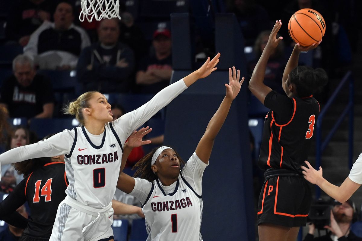 Gonzaga guard Esther Little (0) and Gonzaga forward Destiny Burton (1) defends against a shot by Pacific guard Ayaya James (3) during the first half of a NCAA college basketball game, Thursday, Feb. 16, 2023, in the McCarthey Athletic Center.  (COLIN MULVANY/THE SPOKESMAN-REVIEW)