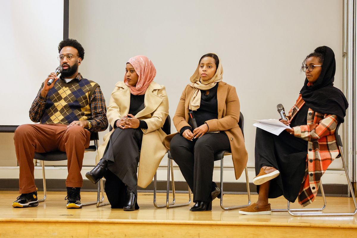 Board member for the Somali Family Safety Task Force Ardo Hersi, far right, moderates a question and answer session with, from left, community legal advocate Abdi Y Jama, deputy legal director of CAIR Faiza Duale and director of OIRA Hamdi Mohamed after during a “Know Your Rights” event Dec. 22 in Seattle.  (Jennifer Buchanan/Seattle Times)