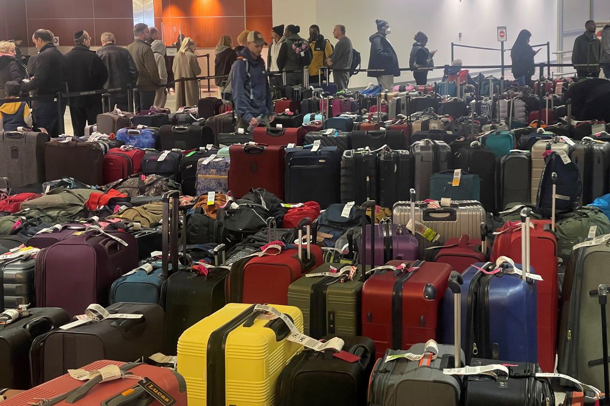 Hundreds of passengers wait in line to handle their baggage claim issues with Southwest Airlines at Baltimore-Washington International Marshall Airport on Tuesday.  (Marvin Joseph/The Washington Post)