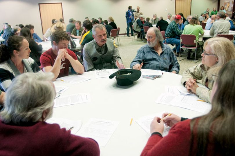 Wildlife biologist Tim Thier, center, answers questions about wolves during a Montana Fish, Wildlife and Parks public workshop focused on proposed changes to the wolf hunting season. - Lido Vizzutti/Flathead Beacon (Lido Vizzutti / Flathead Beacon)