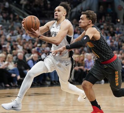 In this April 2, 2019,  photo, San Antonio Spurs’ Derrick White, left, drives past Atlanta Hawks’ Trae Young during the second half of an NBA basketball game, in San Antonio. White’s ascension into the Spurs’ starting lineup and the pivotal role he has played in helping San Antonio earn its 22nd straight postseason appearance was a greater surprise to him than anyone else. (Darren Abate / Associated Press)