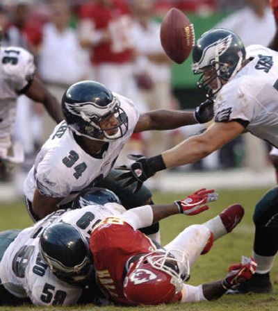 
Eagles defenders, including Mike Labinjo (59), Reno Mahe (34) and Jason Short, look to recover the ball after a fumble by the Chiefs' Dante Hall during the second half at Arrowhead Stadium. Mahe recovered the ball.  
 (Associated Press / The Spokesman-Review)