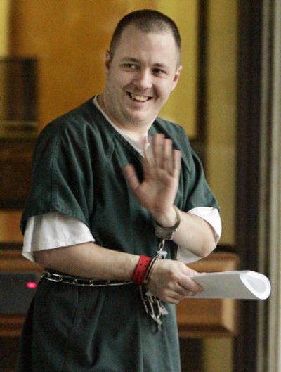 
Daniel McGowan waves to supporters as he  is led to jail after a 2006 court appearance  in Eugene, Ore. 
 (File Associated Press / The Spokesman-Review)