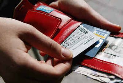 
Marie Jubran uncovers a code on a scratch-off card to access her bank online, in Stockholm, Sweden. 
 (Associated Press / The Spokesman-Review)