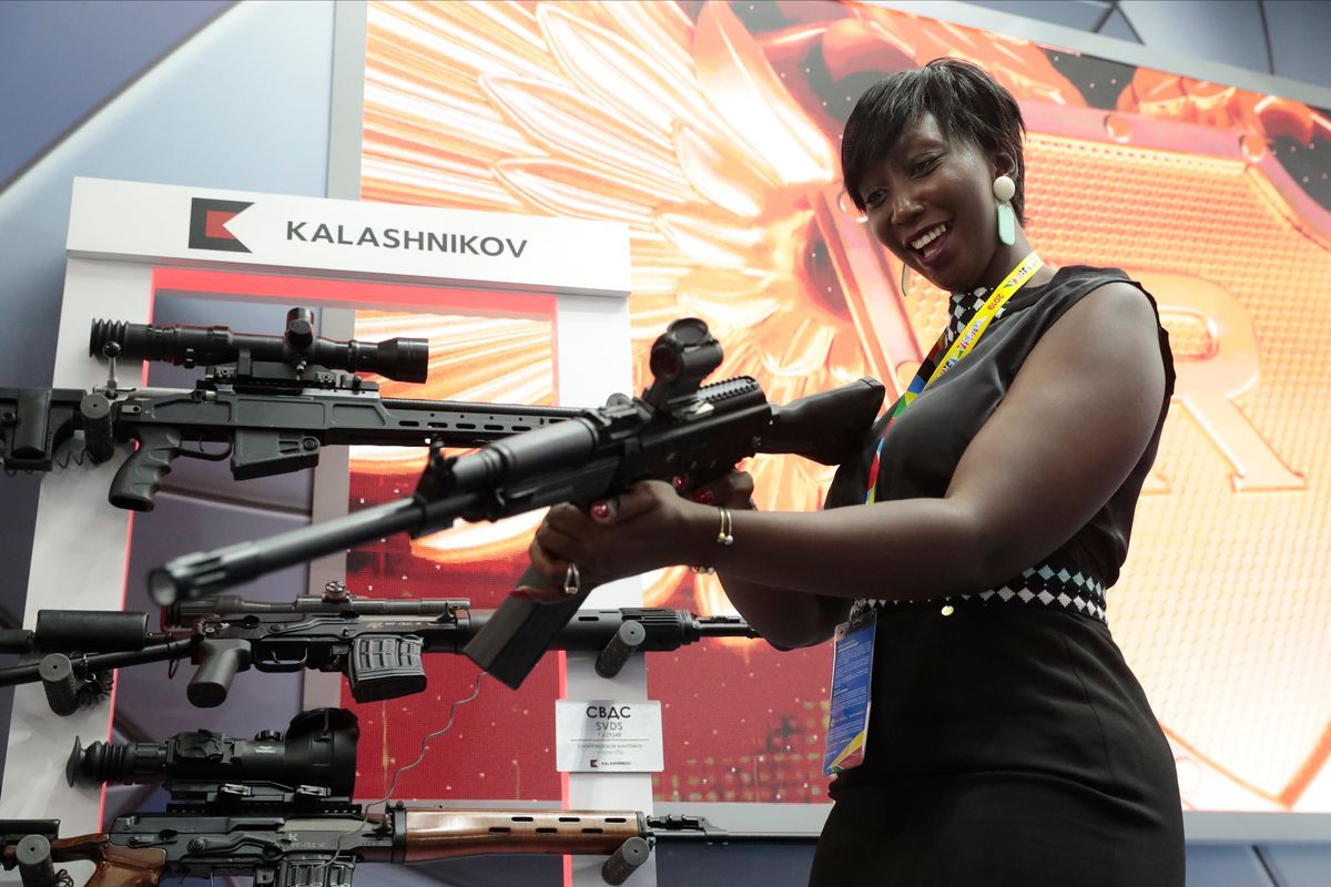 FILE - A visitor handles a gun at an exhibition by the Kalashnikov company on the sidelines of the Russia-Africa summit in the Black Sea resort of Sochi, Russia on Oct. 24, 2019. Amid a worldwide chorus of condemnation against Russia