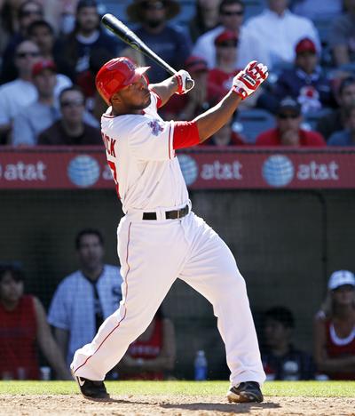 The Angels’ Howie Kendrick connects on his game-winning, three-run home run. (Associated Press)