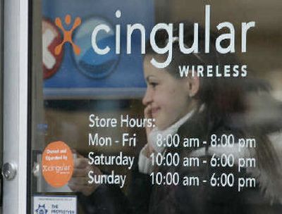 
A customer exits a Cingular store Monday, in New York. 
 (Associated Press / The Spokesman-Review)