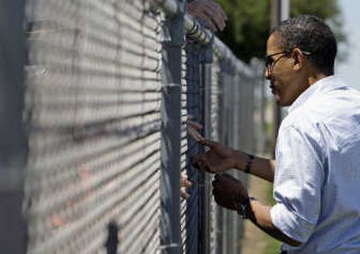 
Democratic presidential candidate Sen. Barack Obama shakes hands through the fence at the airport in Quincy, Ill., Saturday. Associated Press
 (Associated Press / The Spokesman-Review)