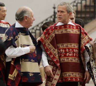 
Chilean President Ricardo Lagos, left, and President George W. Bush wear Chilean ponchos for an APEC photo session in La Moneda, Chile, on Sunday. 
 (Associated Press / The Spokesman-Review)