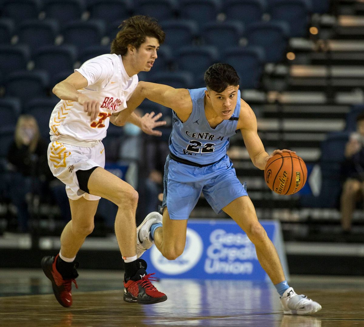 Central Valley guard Dylan Darling dribbles around Kamiakin’s Trey Arland during a State 4A State first-round loser-out game in Tacoma, Wash. on March 2, 2022.  (Patrick Hagerty/For The Spokesman-Review)