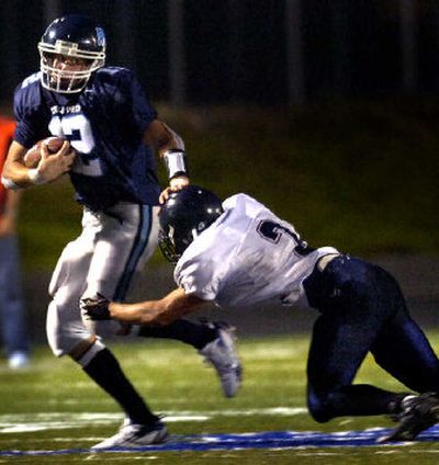 
Gonzaga Prep's Max Manix breaks a tackle by Mt Spokane's Brandon Jared during first-half play on Friday.
 (Jed Conklin / The Spokesman-Review)