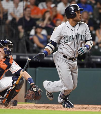 Seattle’s Robinson Cano watches his three-run double in the ninth inning Thursday against Houston. (Eric Christian Smith / Associated Press)