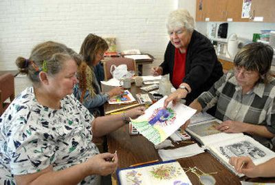 
Rosemary Nichols, standing,  works with clients during an art class at the Women's Hearth. Marilyn Anderson, left, Lea Anne Potter and Catherine Pearce, work on their pieces.
 (Dan Pelle / The Spokesman-Review)