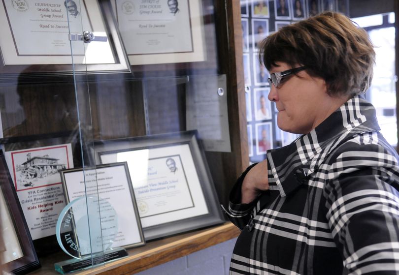 Principal Tammy Fuller reflects on 32 years of achievements displayed in the Mountain View Middle School trophy case. She hopes to find a place for the trophies and awards and is planning events to mark the last days of the school. (J. Bart Rayniak)