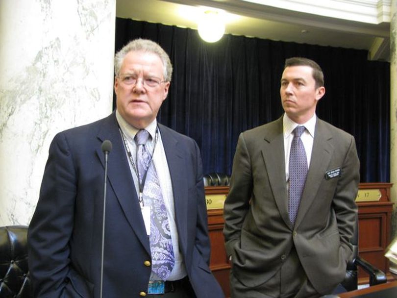 House Minority Leader John Rusche, left, and Minority Caucus Chair Brian Cronin, right, discuss the Democrats' stalling tactics that forced an hour-long reading of a 25-page bill in the House on Wednesday. The minority wants hearings on two bills, a cigarette tax hike and an advisory vote on school reforms, but the majority has refused. (Betsy Russell)