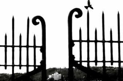 
A fence at the Fort George Wright Cemetery frames the Spokane Veterans Affairs Medical Center several miles away. The hospital is an oasis to thousands of local and regional veterans.
 (Brian Plonka / The Spokesman-Review)