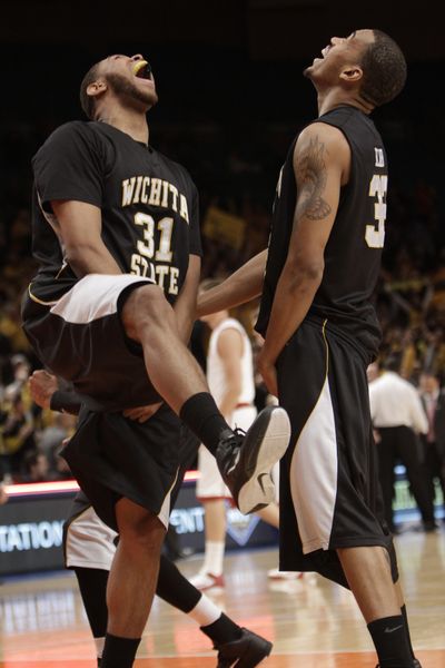 Wichita State’s J.T. Durley, left, and Gabe Blair celebrate after the Shockers won the NIT championship game against Alabama. (Associated Press)