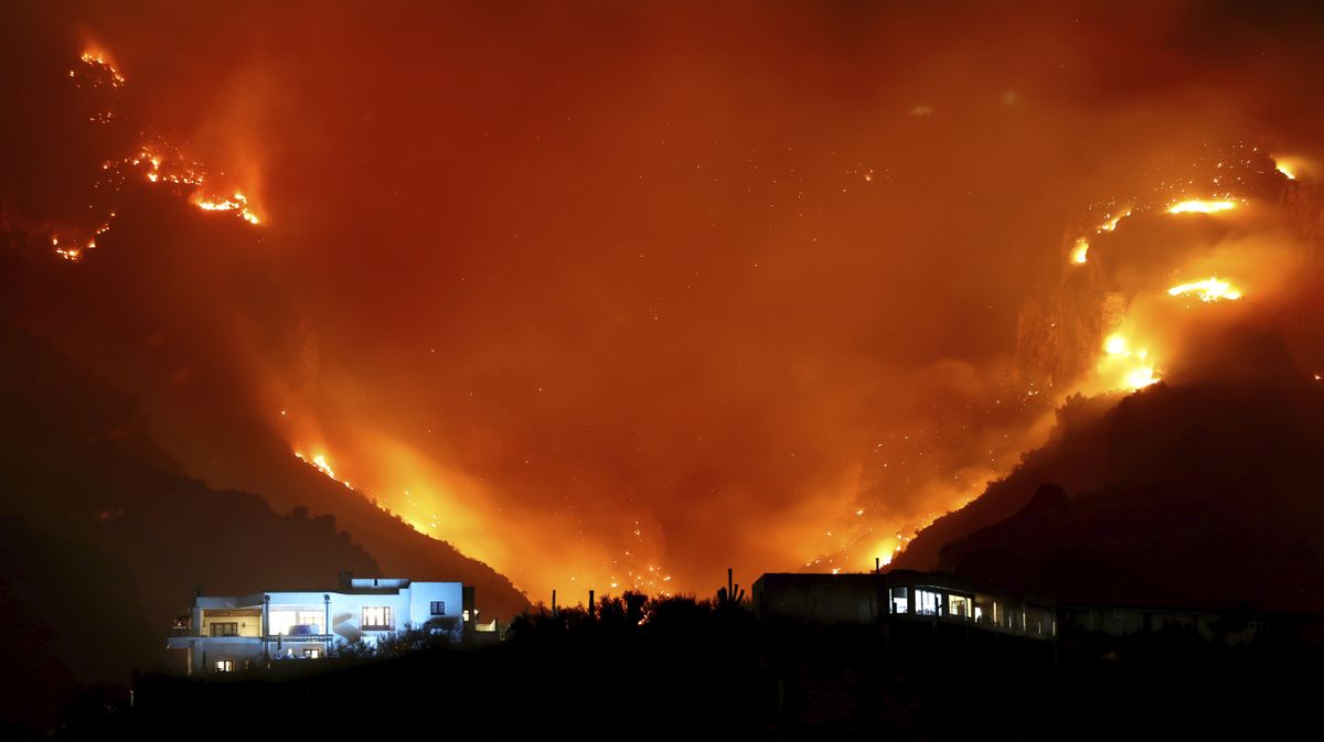 The Bighorn Fire breaks onto the southern slopes of the Santa Catalina Mountains and burns over a pair of homes in the foothills just east of the Finger Rock Trailhead on Wednesday in Tucson, Ariz.  (Kelly Presnell)