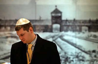 
A visitor stands in front of a picture of death camp Auschwitz-Birkenau, Poland, at the Yad Vashem Holocaust Memorial's new museum Tuesday in Jerusalem.
 (Associated Press / The Spokesman-Review)